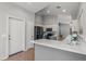 Updated kitchen with white cabinets, stainless steel appliances, and a modern breakfast bar at 10646 E Enid Ave, Mesa, AZ 85208
