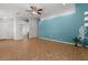 Bright living area with a vibrant accent wall, a ceiling fan, and tile flooring at 10646 E Enid Ave, Mesa, AZ 85208