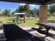 Relaxing park picnic area with tables and shelter, perfect for outdoor gatherings and meals at 10646 E Enid Ave, Mesa, AZ 85208
