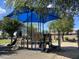 Community playground featuring modern equipment, slides, and a shaded play area at 10646 E Enid Ave, Mesa, AZ 85208