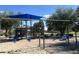 Community playground featuring swings, climbing structures, and a safe, sandy play surface at 10646 E Enid Ave, Mesa, AZ 85208