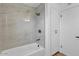 Bright bathroom features a tub and tiled shower with built-in shelving at 10844 N 37Th Way, Phoenix, AZ 85028