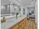 Elegant bathroom featuring double sinks, wood cabinetry, a well-lit mirror, and marble accents at 10844 N 37Th Way, Phoenix, AZ 85028