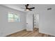 Bedroom with hardwood floors, ceiling fan, and access to walk-in closet at 10844 N 37Th Way, Phoenix, AZ 85028