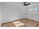 A bright bedroom features wood-look floors and a ceiling fan at 10844 N 37Th Way, Phoenix, AZ 85028