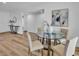 Dining room with a glass-top table, modern chairs and wood flooring, perfect for Gathering meals and entertaining at 10844 N 37Th Way, Phoenix, AZ 85028