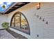 Close up of arched window with house numbers and a brick facade at 10844 N 37Th Way, Phoenix, AZ 85028