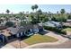 Charming single-story home with a well-manicured lawn, a driveway, and mature palm trees at 10844 N 37Th Way, Phoenix, AZ 85028