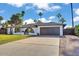 A home featuring a lush green lawn, desert plants, and a two-car garage sits below a beautiful partly cloudy sky at 10844 N 37Th Way, Phoenix, AZ 85028