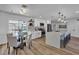 Bright kitchen featuring white cabinets, stainless steel appliances, a kitchen island with seating, and adjacent breakfast area at 10844 N 37Th Way, Phoenix, AZ 85028