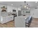 Modern kitchen featuring stainless appliances, white cabinets, large center island with seating and hardwood floors at 10844 N 37Th Way, Phoenix, AZ 85028