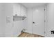 Bright laundry room with storage cabinets, and hardwood flooring at 10844 N 37Th Way, Phoenix, AZ 85028