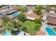 The aerial view shows a large backyard with mature trees and greenery providing privacy and shade at 11011 N 39Th St, Phoenix, AZ 85028