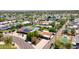 This aerial view highlights mature landscaping, swimming pools, and houses with solar panels in a neighborhood at 11011 N 39Th St, Phoenix, AZ 85028