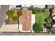 An aerial top-down view of a house featuring mature trees, a lawn, and a driveway at 11011 N 39Th St, Phoenix, AZ 85028