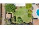 Private backyard featuring a large grassy area perfect for outdoor activities, mature trees and shrubs at 11011 N 39Th St, Phoenix, AZ 85028