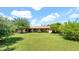 Lush backyard featuring mature trees, a well-kept lawn, and a covered patio offering a serene outdoor retreat at 11011 N 39Th St, Phoenix, AZ 85028