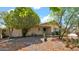 Charming single-story home featuring a low-maintenance yard with mature trees and desert landscaping at 11011 N 39Th St, Phoenix, AZ 85028