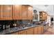 A kitchen featuring granite counters, wood cabinets, stainless steel appliances, and a large window above the sink at 11011 N 39Th St, Phoenix, AZ 85028