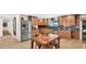 Bright eat-in kitchen featuring stainless steel appliances, granite countertops, wood cabinets, and a wooden table at 11011 N 39Th St, Phoenix, AZ 85028