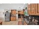 A modern kitchen with stainless steel appliances, granite counters, wood cabinets, and lots of natural light at 11011 N 39Th St, Phoenix, AZ 85028