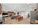Open living space featuring tile floors and a dining area with a wooden table, next to a fireplace and kitchen at 11011 N 39Th St, Phoenix, AZ 85028