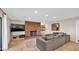 An open-concept living room with a brick fireplace, and a comfortable gray sectional sofa on tile floors at 11011 N 39Th St, Phoenix, AZ 85028