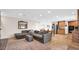 Open floor plan showcases a living room with tile flooring and a gray sectional near the kitchen and dining area at 11011 N 39Th St, Phoenix, AZ 85028