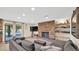Cozy living room featuring a stone fireplace, built-in shelving, and a sliding glass door to the backyard at 11011 N 39Th St, Phoenix, AZ 85028