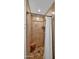 Tiled shower with glass door, built-in shelving, and sleek fixtures at 11011 N 39Th St, Phoenix, AZ 85028