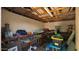 Interior of a storage shed with open wood ceiling, filled with organized storage shelves and tools at 11011 N 39Th St, Phoenix, AZ 85028