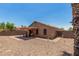 Cozy backyard features a covered patio area and a low-maintenance desert landscape at 1180 W Rosal Ave, Apache Junction, AZ 85120