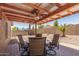 Relaxing covered patio with outdoor seating, perfect for enjoying backyard views at 1180 W Rosal Ave, Apache Junction, AZ 85120