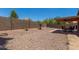 Desert backyard showcases gravel landscaping, brick patio, and covered outdoor dining area at 1180 W Rosal Ave, Apache Junction, AZ 85120
