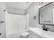 Bathroom featuring a shower-tub combo, dark fixtures, and neutral finishes at 1180 W Rosal Ave, Apache Junction, AZ 85120