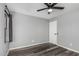 Bedroom featuring hard surface floors, ceiling fan, and a window allowing natural light at 1180 W Rosal Ave, Apache Junction, AZ 85120