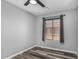 Bright bedroom featuring modern ceiling fan, window with natural light, and durable wood-look floors at 1180 W Rosal Ave, Apache Junction, AZ 85120