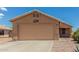 Beige single-story house with a large garage and desert landscaping at 1180 W Rosal Ave, Apache Junction, AZ 85120