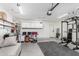 Spacious garage featuring work out area, work bench, storage and epoxied floors at 1180 W Rosal Ave, Apache Junction, AZ 85120