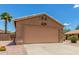 Beige single-story house with a large garage and palm tree at 1180 W Rosal Ave, Apache Junction, AZ 85120