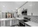 Kitchen featuring modern stainless steel appliances, gray cabinets, and white countertops at 1180 W Rosal Ave, Apache Junction, AZ 85120