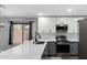 Kitchen featuring gray and white cabinets, stainless appliances, tile backsplash, and views of the outdoors at 1180 W Rosal Ave, Apache Junction, AZ 85120