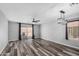 Spacious living room with dark wood-look floors and large windows at 1180 W Rosal Ave, Apache Junction, AZ 85120