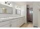 Bathroom showcasing dual sinks with modern fixtures and a shower with modern features at 1235 E Dover St, Mesa, AZ 85203