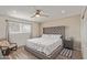 Comfortable bedroom with a ceiling fan, a large window, and wood-look floors at 1235 E Dover St, Mesa, AZ 85203