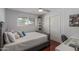 Bedroom with hardwood floors, a cozy bed, and a sliding-door closet at 1235 E Dover St, Mesa, AZ 85203