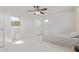Cozy bedroom with tile flooring, air conditioning unit, ceiling fan, and a door to the outside at 1235 E Dover St, Mesa, AZ 85203