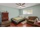 Bedroom featuring hardwood floors, a ceiling fan, and comfortable furnishings at 1235 E Dover St, Mesa, AZ 85203