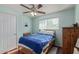 Bedroom featuring a ceiling fan, window, wood floor, and a comfortable bed at 1235 E Dover St, Mesa, AZ 85203
