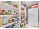 Organized pantry with lots of shelving and a side-by-side refrigerator at 1235 E Dover St, Mesa, AZ 85203
